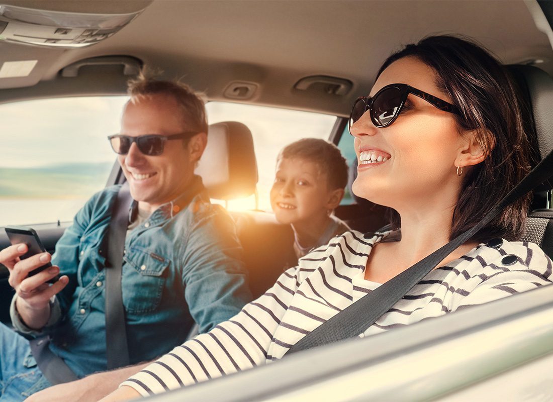 Personal Insurance - Happy Family Riding Together in a Car on a Roadtrip